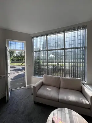 a living room with a couch and large windows at Riverside by Teil in Preston