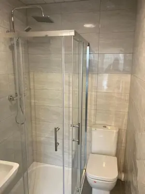 a bathroom with a shower and a toilet and a sink at Riverside by Teil in Preston