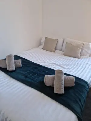 a large bed with three towels on it at Riverside by Teil in Preston