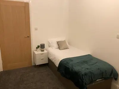 a small bedroom with a bed and a night stand at Riverside by Teil in Preston