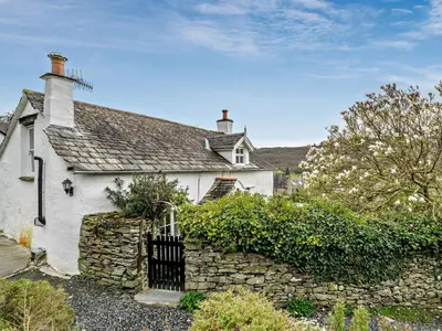 a white house with a stone wall at 3 Bed in Ulverston oc-91779 in Haverthwaite
