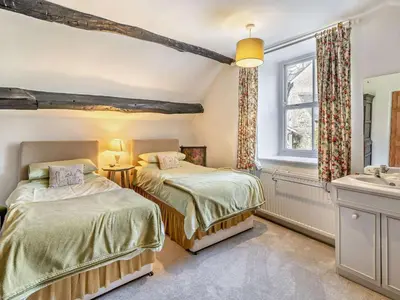 a bedroom with two beds and a sink at 3 Bed in Ulverston oc-91779 in Haverthwaite