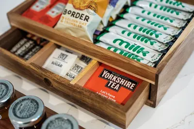 a wooden box filled with different types of cheese at Bramley Brook Cottage 5* Luxury in Whalley