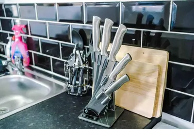 a bunch of knives on a cutting board next to a sink at Spacious One-Bedroom Apartment in Saint Helens in Saint Helens