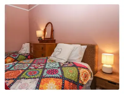 a bedroom with a bed with a pillow and a dresser at Sunnycote in Arnside