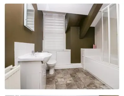 a bathroom with a sink and a toilet and a bath tub at Sunnycote in Arnside