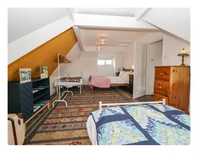 a bedroom with a bed and a room with a bed sqor at Sunnycote in Arnside