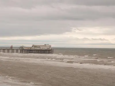 a pier on the beach with the ocean at 19 Slinger Road in Cleveleys