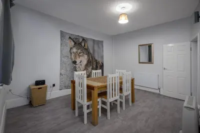 a dining room with a wolf painting on the wall at Beautiful Family Home in Blackpool for you in Blackpool