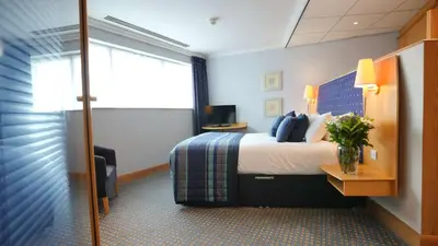 a hotel room with a bed and a window at The Bolton Stadium Hotel, a member of Radisson Individuals in Bolton