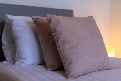 a group of pillows sitting on top of a bed at St Davids House - Air Host & Stay - 4 Bedrooms - Contractor Friendly in Liverpool