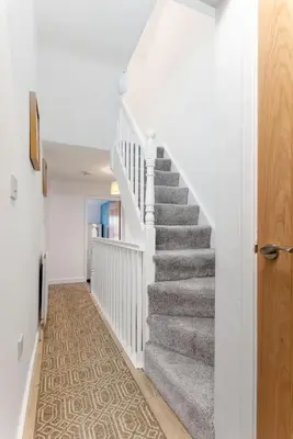 a staircase in a home with white walls and a stair case at St Davids House - Air Host & Stay - 4 Bedrooms - Contractor Friendly in Liverpool