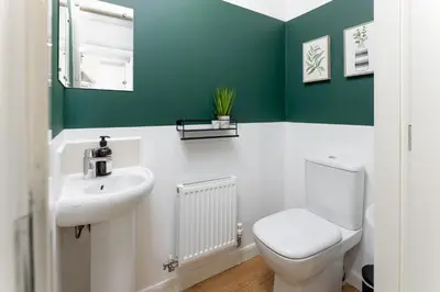 a bathroom with a white toilet and a sink at Modern 2-Bed Townhouse in Kirkdale in Liverpool