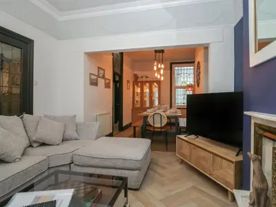 a living room with a couch and a tv at West End Bay in Morecambe