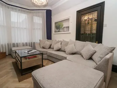 a living room with a couch and a table at West End Bay in Morecambe