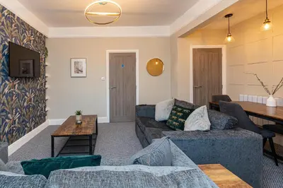a living room with two couches and a table at Beachfront Apartment 3 Bedrooms Sleeps 7 - Gateway to the Lake District - Newly Refurbished in Morecambe