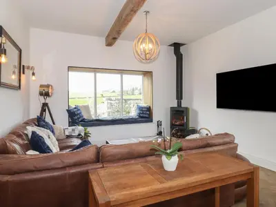 a living room with a couch and a table at Old Watermill in Grange Over Sands