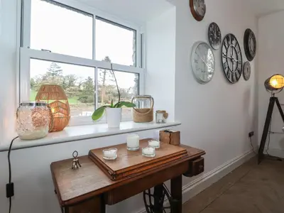 a room with a wooden table and a window at Old Watermill in Grange Over Sands