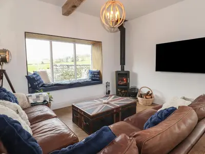 a living room with a couch and a tv at Old Watermill in Grange Over Sands