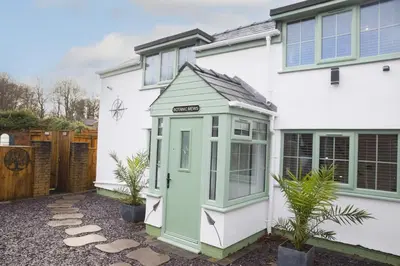 a small house with a green out door at Botanic Mews in Southport