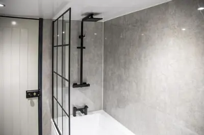 a shower stall in a bathroom with a sink at Botanic Mews in Southport