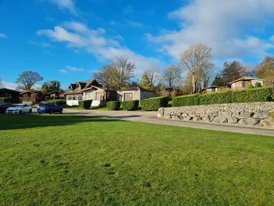 a driveway in a residential neighborhood with houses at Sherwood 33 in Carnforth