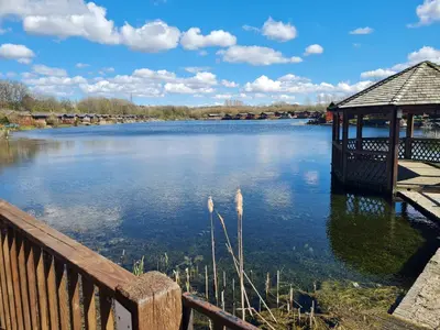 a view of a lake with a gazebo at Sherwood 33 in Carnforth