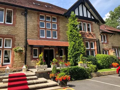 a house with a red rug in front of it at Springbank Manor in Darwen