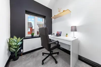 an office with a desk and a chair and a window at Luxury by the Sea, Beautiful 3 bedroom House with Fast WiFi, King Bed, Lovely Garden! Blackpool's Finest Getaway Experience for up to 8 Guests! in Blackpool