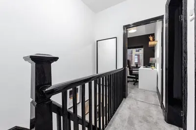 a room with a staircase with a mirror and a chair at Luxury by the Sea, Beautiful 3 bedroom House with Fast WiFi, King Bed, Lovely Garden! Blackpool's Finest Getaway Experience for up to 8 Guests! in Blackpool