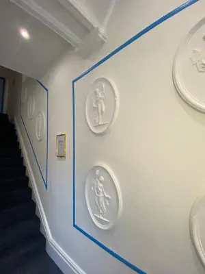 a hallway with three plates on the wall at The New Athena Hotel in Blackpool