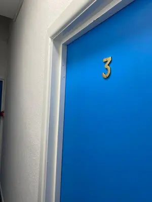a blue door with the number three on it at The New Athena Hotel in Blackpool