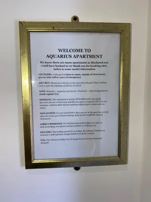 a sign in a frame hanging on a wall at AQUARIUS APARTMENT - SEA VIEW - SLEEPS SEVEN in Blackpool