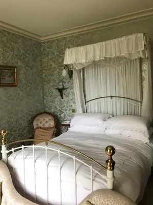 a bedroom with a white bed with a canopy at st marys mount in Ulverston