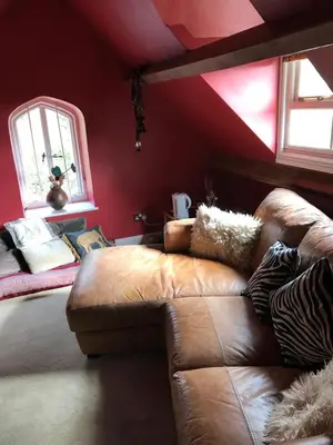 a living room with a couch and a red ceiling at st marys mount in Ulverston