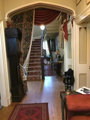 a living room with a staircase and a rug at st marys mount in Ulverston