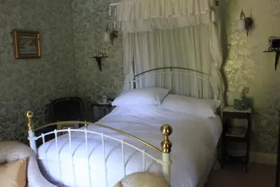 a bedroom with a white bed with a canopy at st marys mount in Ulverston