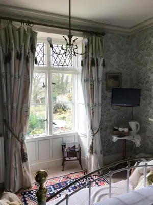 a bedroom with a bed and a window at st marys mount in Ulverston