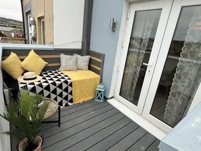 a balcony with a bed on a porch at 23 Coastal Comfort in Millom