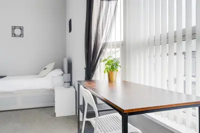 a dining room with a table and a bed at 4-Bed Contractor House Sleeps 7 Free Parking L20 Liverpool - Hosted by By Hinkley Homes Short Lets & Serviced Accommodation in Liverpool