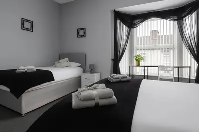 a bedroom with a bed and a large window at 4-Bed Contractor House Sleeps 7 Free Parking L20 Liverpool - Hosted by By Hinkley Homes Short Lets & Serviced Accommodation in Liverpool