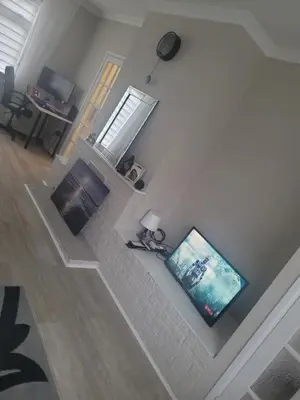 an aerial view of a living room with a fireplace and a television at NB's Cozy Nook, WIGAN in Shevington