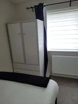 a bedroom with a bed and a dresser and a window at NB's Cozy Nook, WIGAN in Shevington