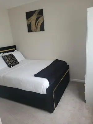 a bedroom with a black and white bed in a room at NB's Cozy Nook, WIGAN in Shevington