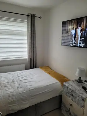 a bedroom with a bed and a picture on the wall at NB's Cozy Nook, WIGAN in Shevington