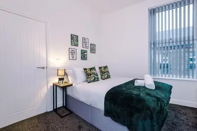 a white bedroom with a bed and a window at Rocky Lane Urban Apartments by Charming Apartments - Flat 3 in Liverpool