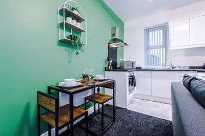 a kitchen with a small table in a room at Rocky Lane Urban Apartments by Charming Apartments - Flat 3 in Liverpool