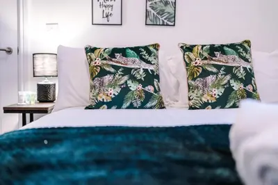 a bedroom with a bed with two pillows at Rocky Lane Urban Apartments by Charming Apartments - Flat 3 in Liverpool