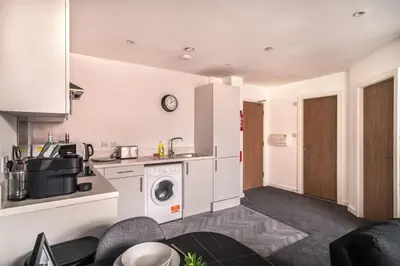a kitchen with a washer and dryer in a room at Contemporary 1 Bed Apartment in Central Preston in Preston