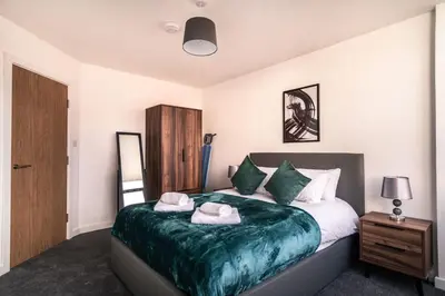 a bedroom with a large bed with towels on it at Contemporary 1 Bed Apartment in Central Preston in Preston